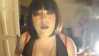 Chubby Dominatrix Tina Smua Puffs On A Unfiltered Cigarette With A Holder